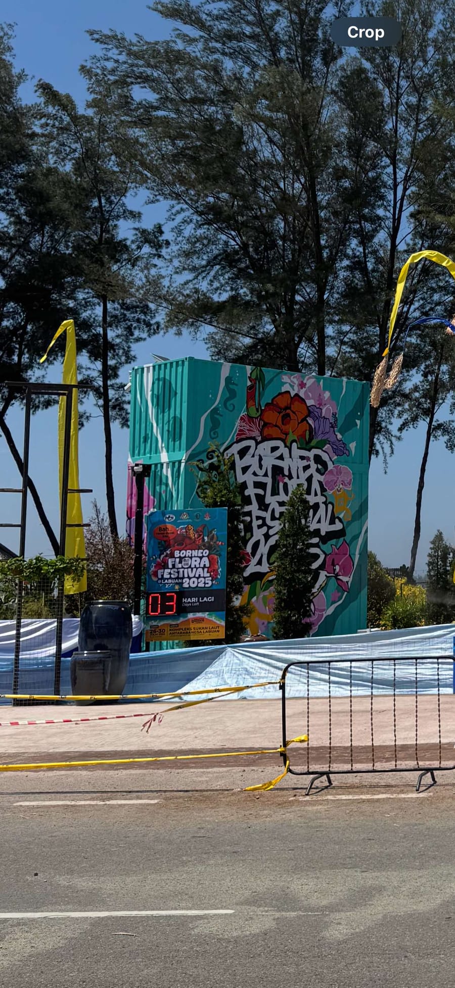 Festival entrance container painted with Borneo Flora Festival 2025 artwork and a days-left countdown board